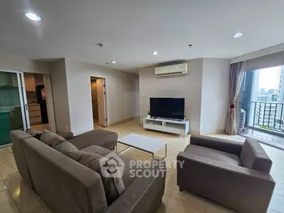 Spacious living room with modern furniture and city view balcony