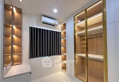 Luxurious walk-in closet with elegant lighting and ample storage space