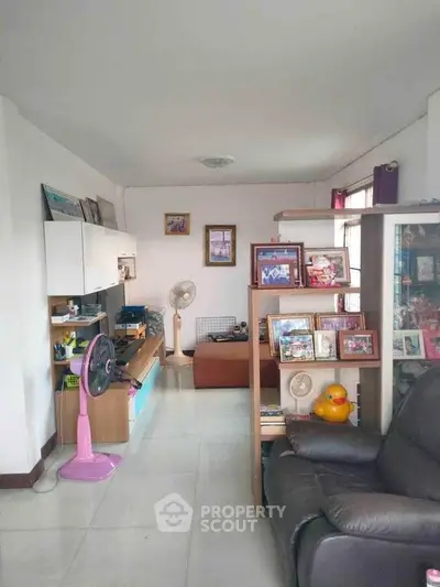Spacious living room with modern decor and ample natural light, perfect for relaxation and entertainment.