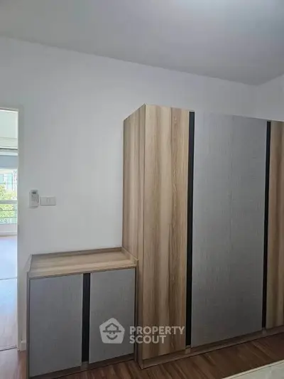 Modern bedroom with stylish wooden wardrobe and sleek design
