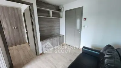 Modern apartment interior with sleek wooden cabinetry and cozy leather sofa