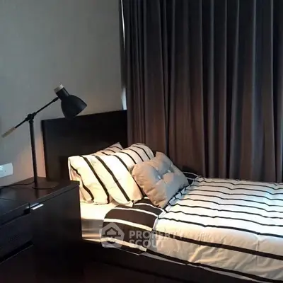 Cozy bedroom with modern decor and stylish striped bedding