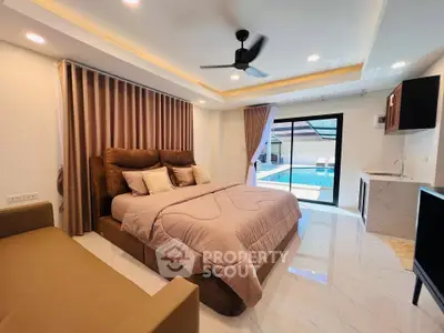 Luxurious bedroom with pool view, modern furnishings, and elegant lighting, perfect for relaxation and comfort.