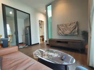 Modern living room with stylish furniture and open kitchen layout
