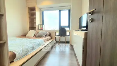 Modern bedroom with large window and stylish decor in urban apartment