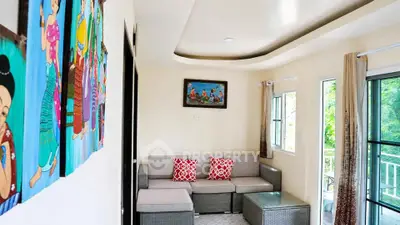 Charming living room with modern decor and vibrant artwork, featuring cozy seating and natural light.