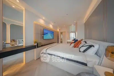 Luxurious modern bedroom with elegant decor and ambient lighting, featuring a large bed and wall-mounted TV.