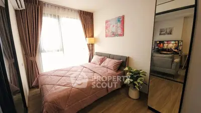 Cozy bedroom with modern decor and large window for natural light.