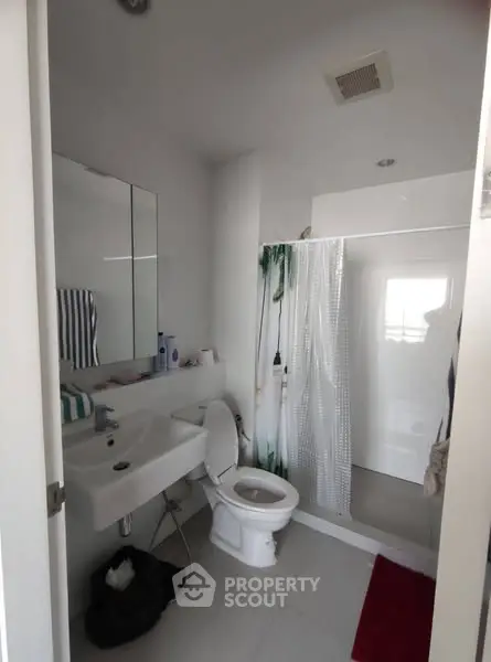 Modern bathroom with shower and sleek fixtures in a contemporary home.