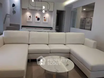 Modern living room with stylish sectional sofa and marble coffee table
