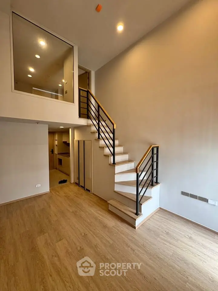 Modern duplex interior with wooden flooring and stylish staircase, perfect for contemporary living.