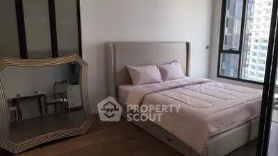 Modern bedroom with elegant decor and large mirror in a high-rise apartment