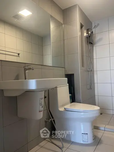 Modern bathroom with sleek fixtures and a spacious shower area.