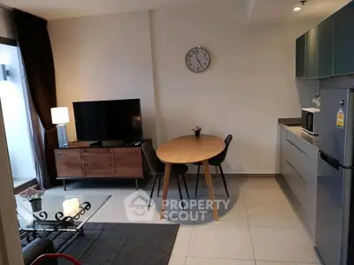 Modern living room with sleek kitchen and stylish furniture, perfect for urban living.