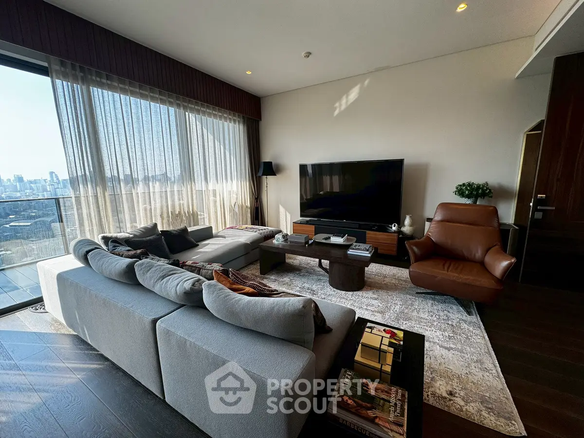Luxurious living room with panoramic city view, modern furniture, and elegant decor.