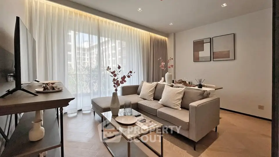 Elegant living room with modern decor and large window offering natural light