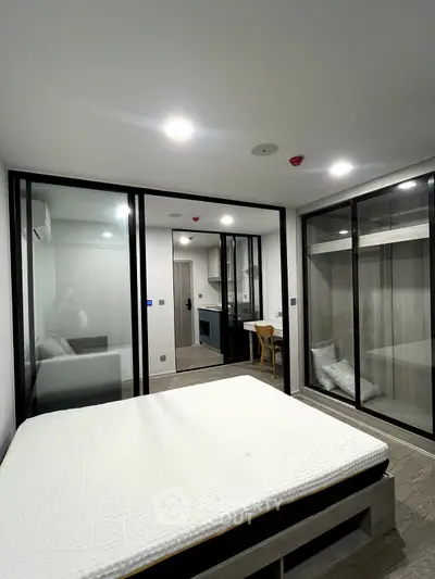 Modern bedroom with glass partitions and minimalist design in a stylish apartment