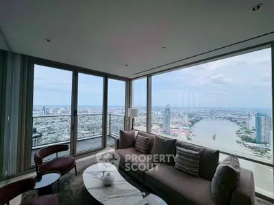 Luxurious living room with panoramic city and river views from floor-to-ceiling windows.