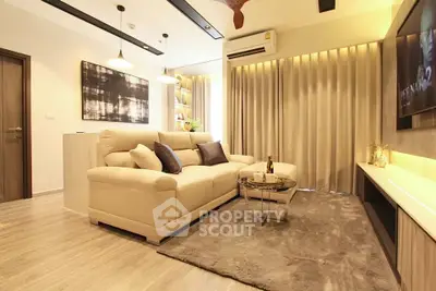 Modern living room with cozy beige sofa, stylish decor, and ambient lighting