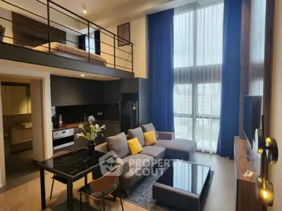 Modern loft apartment with high ceilings, stylish living area, and mezzanine bedroom.