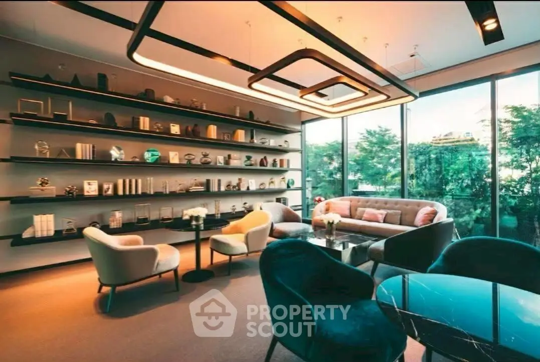 Luxurious modern living room with elegant furniture and large windows offering a serene garden view.