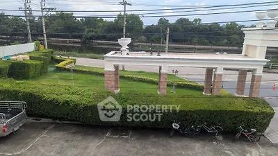 Charming garden view with lush greenery and elegant entrance, perfect for serene living.