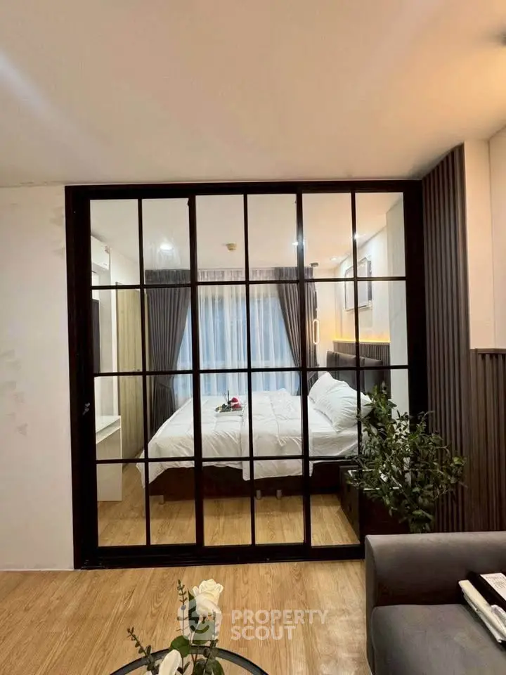 Modern bedroom with glass partition and cozy decor