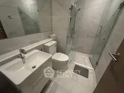 Modern bathroom with sleek fixtures and glass shower enclosure