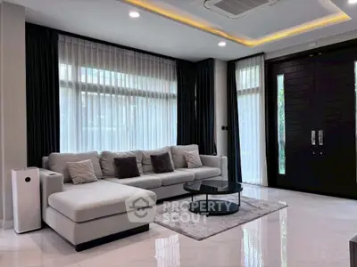 Luxurious modern living room with sleek furniture and large windows for natural light.