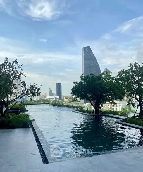 Luxurious rooftop pool with stunning city skyline view and lush greenery.