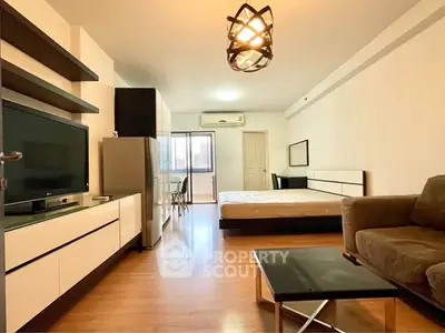 Spacious studio apartment with modern furnishings and natural light.