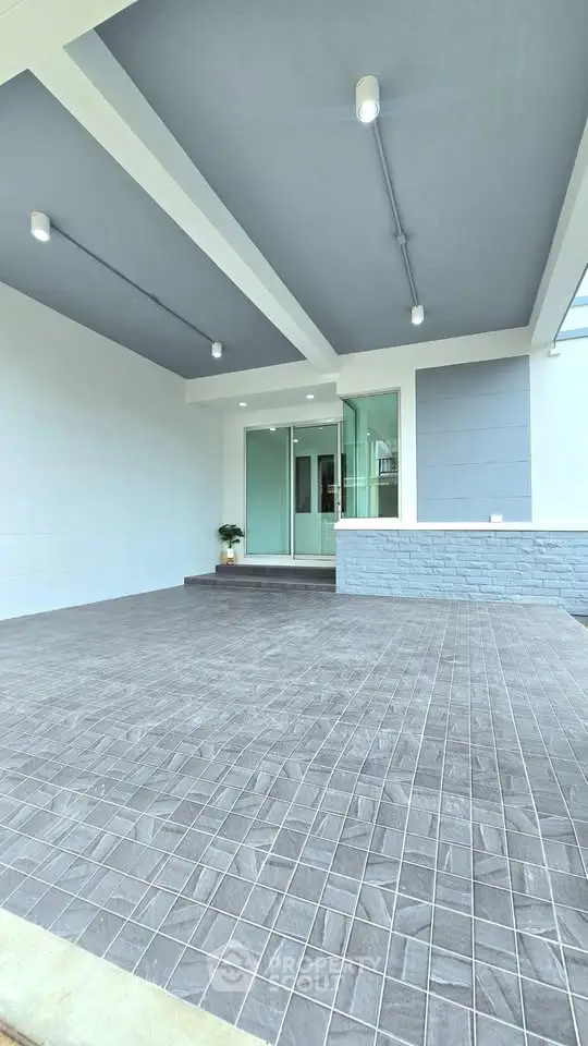 Modern home entrance with covered patio and sleek design