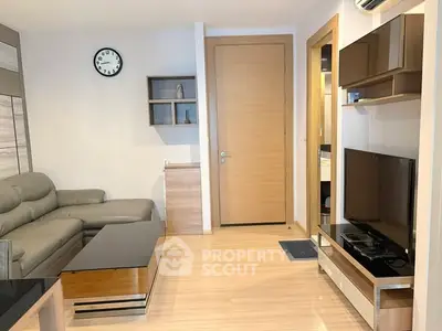 Modern living room with sleek furniture and wall-mounted TV, featuring a cozy ambiance and stylish decor.