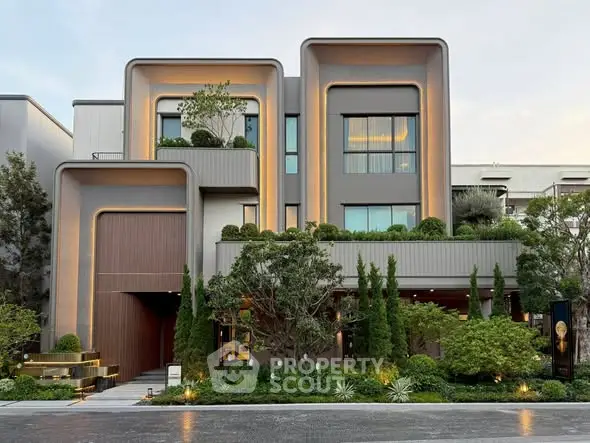 Modern architectural masterpiece with lush landscaping and unique facade design.