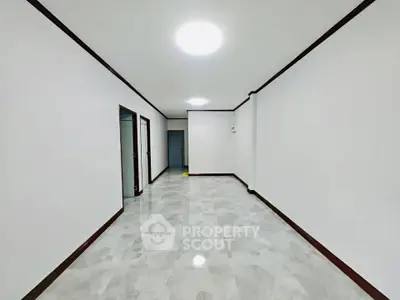 Spacious minimalist interior with sleek white walls and modern lighting