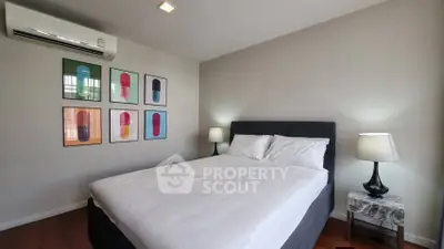 Modern bedroom with stylish decor and comfortable bed in a well-lit space.