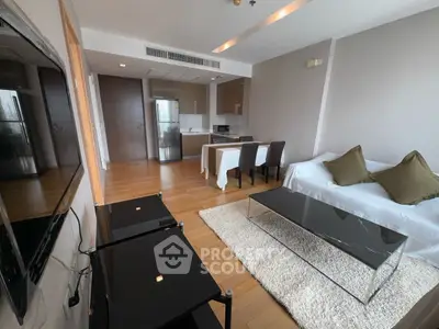 Modern living room with sleek furniture and open kitchen layout