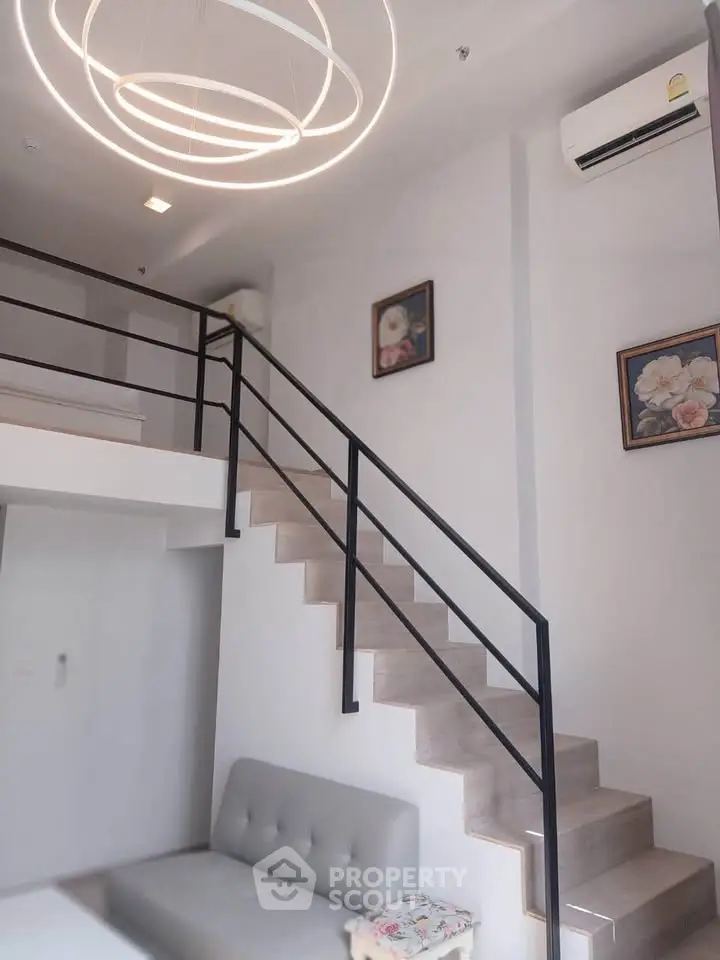 Modern loft-style living room with elegant staircase and chic lighting