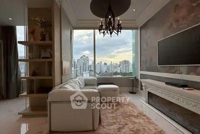 Luxurious living room with stunning city view, elegant chandelier, and modern decor.