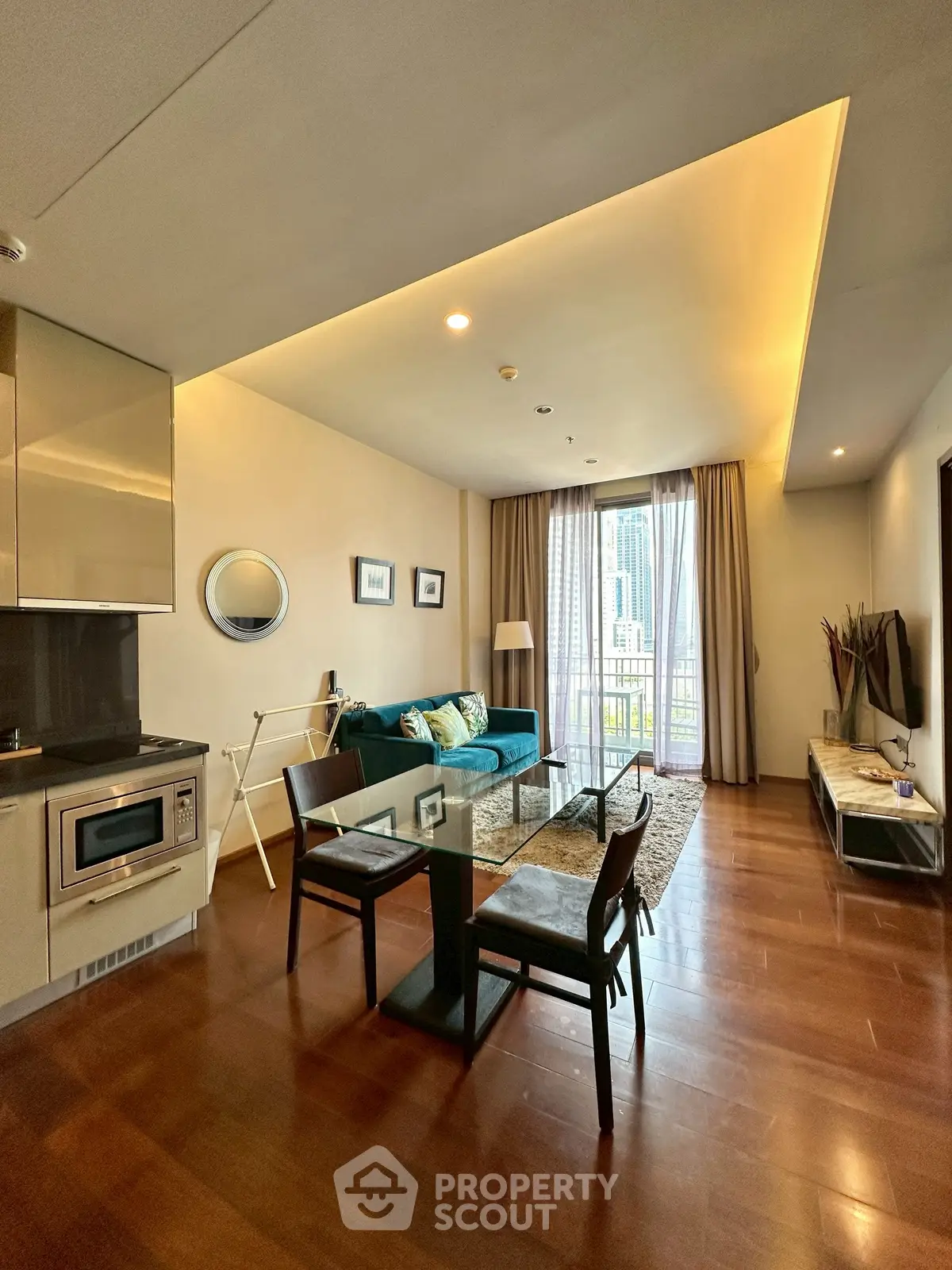 Modern living room with open kitchen and city view balcony