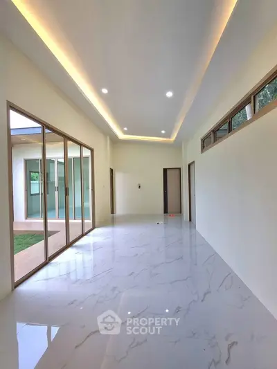 Spacious modern interior with marble flooring and large windows