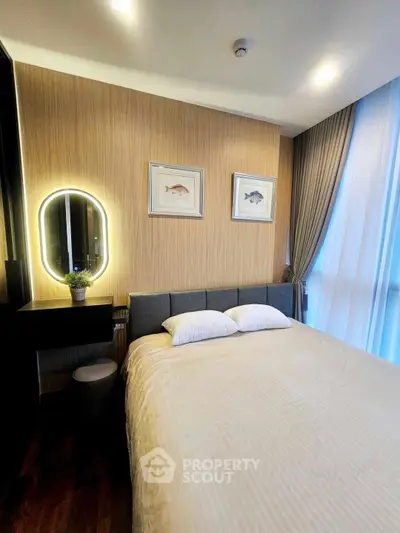 Cozy bedroom with modern decor and soft lighting, featuring a comfortable bed and elegant wall art.