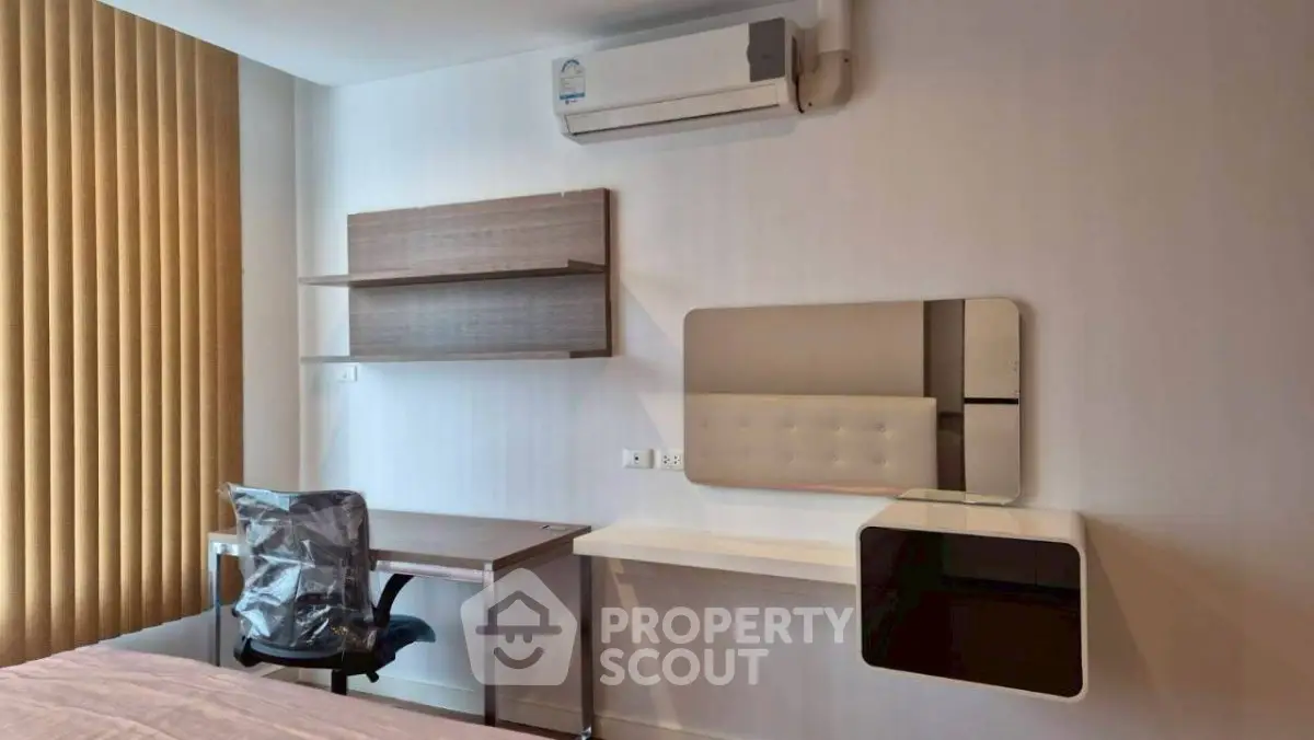 Modern bedroom with study desk and air conditioning in a stylish apartment