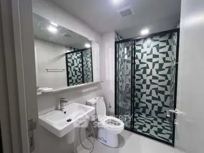 Modern bathroom with geometric tile shower and sleek fixtures