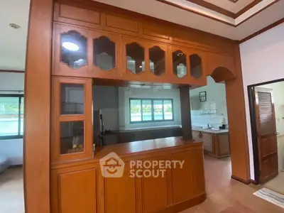 Spacious kitchen with elegant wooden cabinetry and open layout design