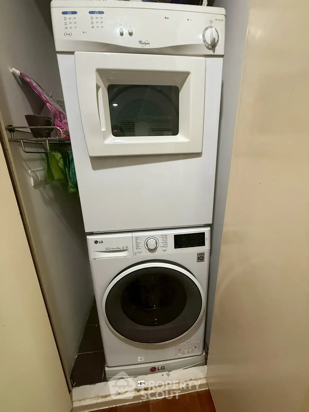 Compact laundry area with stacked washer and dryer in a modern home.
