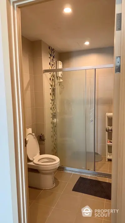 Modern bathroom with glass shower enclosure and sleek tile design