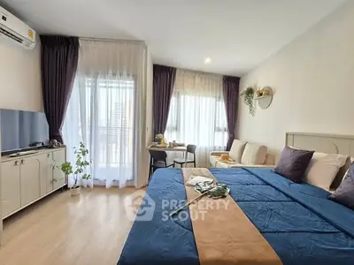 Modern bedroom with stylish decor and natural light in a cozy apartment.