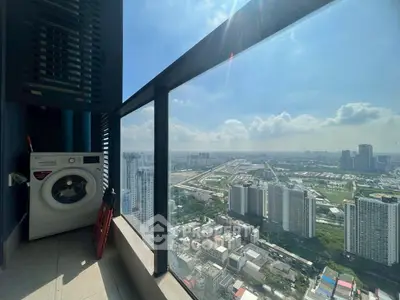Stunning high-rise balcony view with washing machine and cityscape panorama.