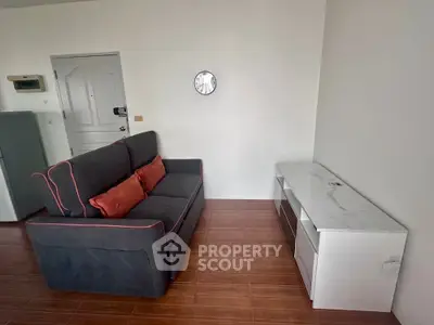 Cozy living room with modern sofa and sleek white cabinet, perfect for relaxation and entertainment.